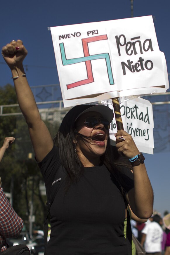 रविवार को प्रदर्शन के दौरान गिरफ्तार अपने साथियों की रिहाई के लिए मेक्सको सिटी में रैली निकालते प्रदर्शनकारी।
