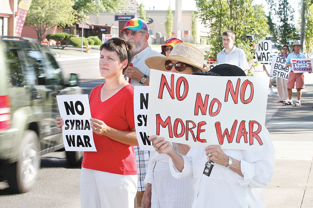 सीरिया में अमेरिकी हमले की आशंका के बीच विरोध- प्रदर्शन करते लोग।