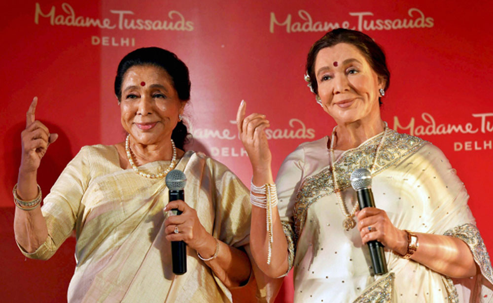 Legendary singer Asha Bhosle poses with her wax-statue during its unveiling, in New Delhi. The statue will be installed at the Madame Tussauds Delhi. Legendary singer Asha Bhosle poses with her wax-statue during its unveiling, in New Delhi. The statue will be installed at the Madame Tussauds Delhi.