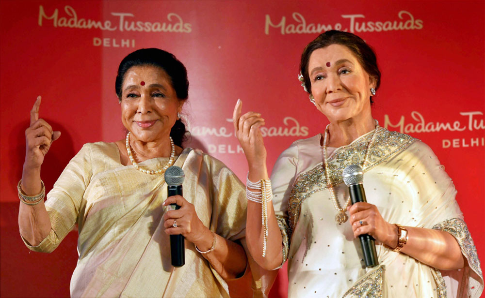 Legendary singer Asha Bhosle poses with her wax-statue during its unveiling, in New Delhi. Legendary singer Asha Bhosle poses with her wax-statue during its unveiling, in New Delhi.