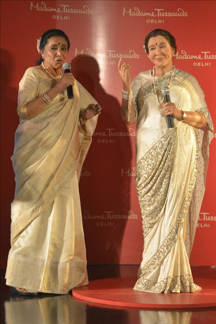 Veteran singer Asha Bhosle with her wax statue that was unveiled at the Madame Tussauds museum in New Delhi. Veteran singer Asha Bhosle with her wax statue that was unveiled at the Madame Tussauds museum in New Delhi.