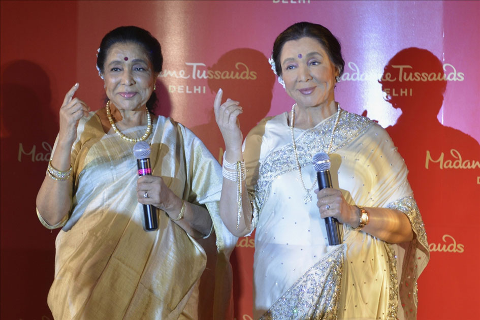 Veteran singer Asha Bhosle with her wax statue that was unveiled at the Madame Tussauds museum in New Delhi. Veteran singer Asha Bhosle with her wax statue that was unveiled at the Madame Tussauds museum in New Delhi.