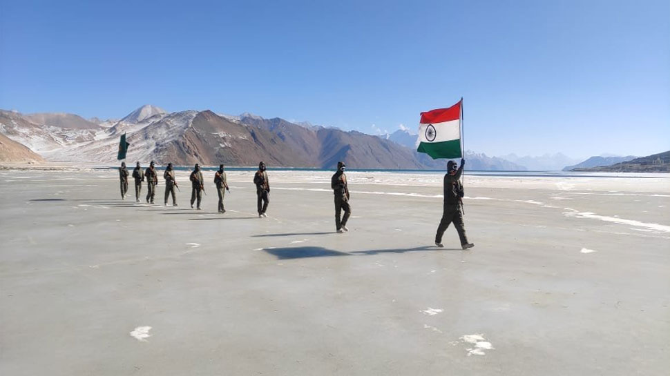 Indo Tibetan Border Police jawans marching with the national flag on a frozen water body in Ladakh on Republic Day 2021