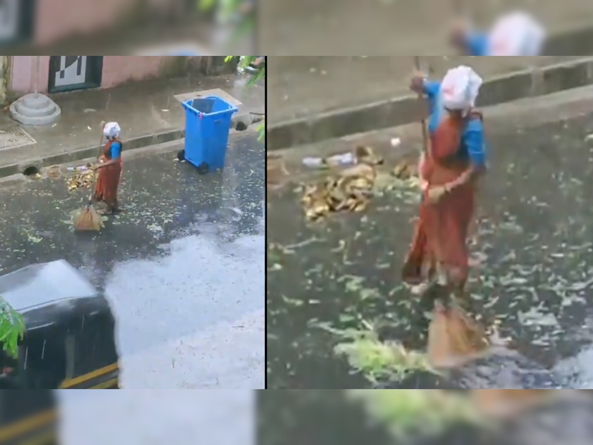 तूफान और बारिश में भीगते हुए महिला ने लगाई सड़क पर झाड़ू