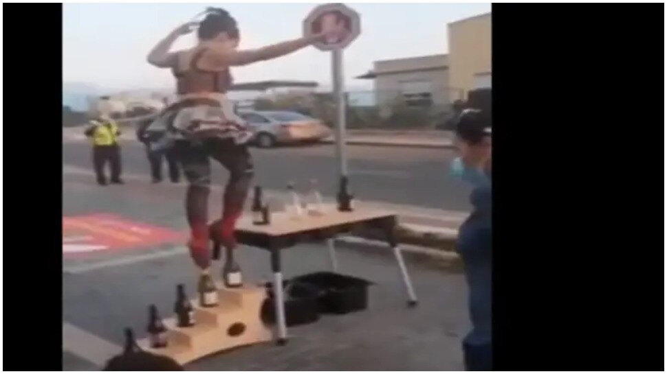 viral video of woman doing stunt on glass bottles balancing act amazing