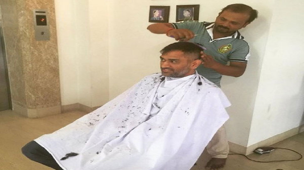 Dhoni having hair cut from local barber 