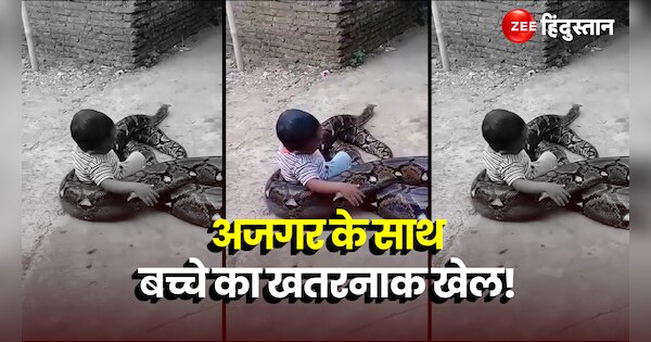 A kid is seen playing with a python and then sitting on its back and ...