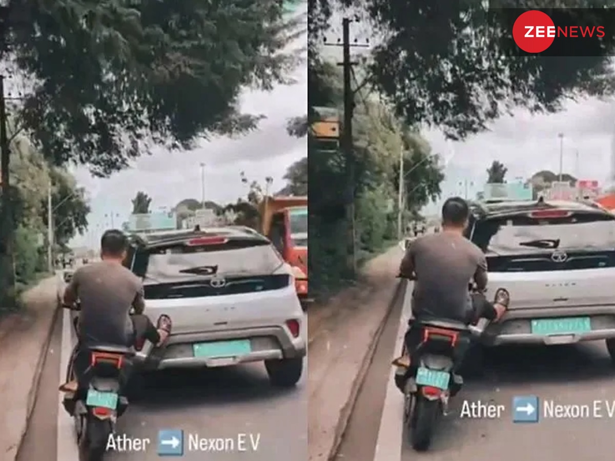 Viral Video: बीच सड़क पर फंस गई इलेक्ट्रिक गाड़ी, फिर बाइक वाले ने लात से यूं धकेला