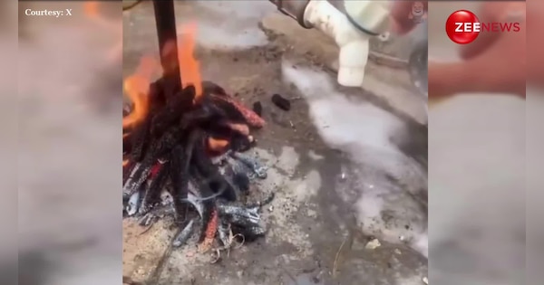 man put fire under tap desi jugaad to keep water warm in winters | लो जनाब जाड़े से निपटने का मिल गया रामबाण इलाज, शख्स ने नल के नीचे ही लगा डाली आग; देखें VIDEO | Zee News Hindi