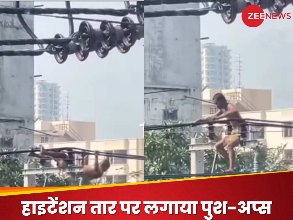 man climbed a pole on electric wire push-ups holding a high tension ...