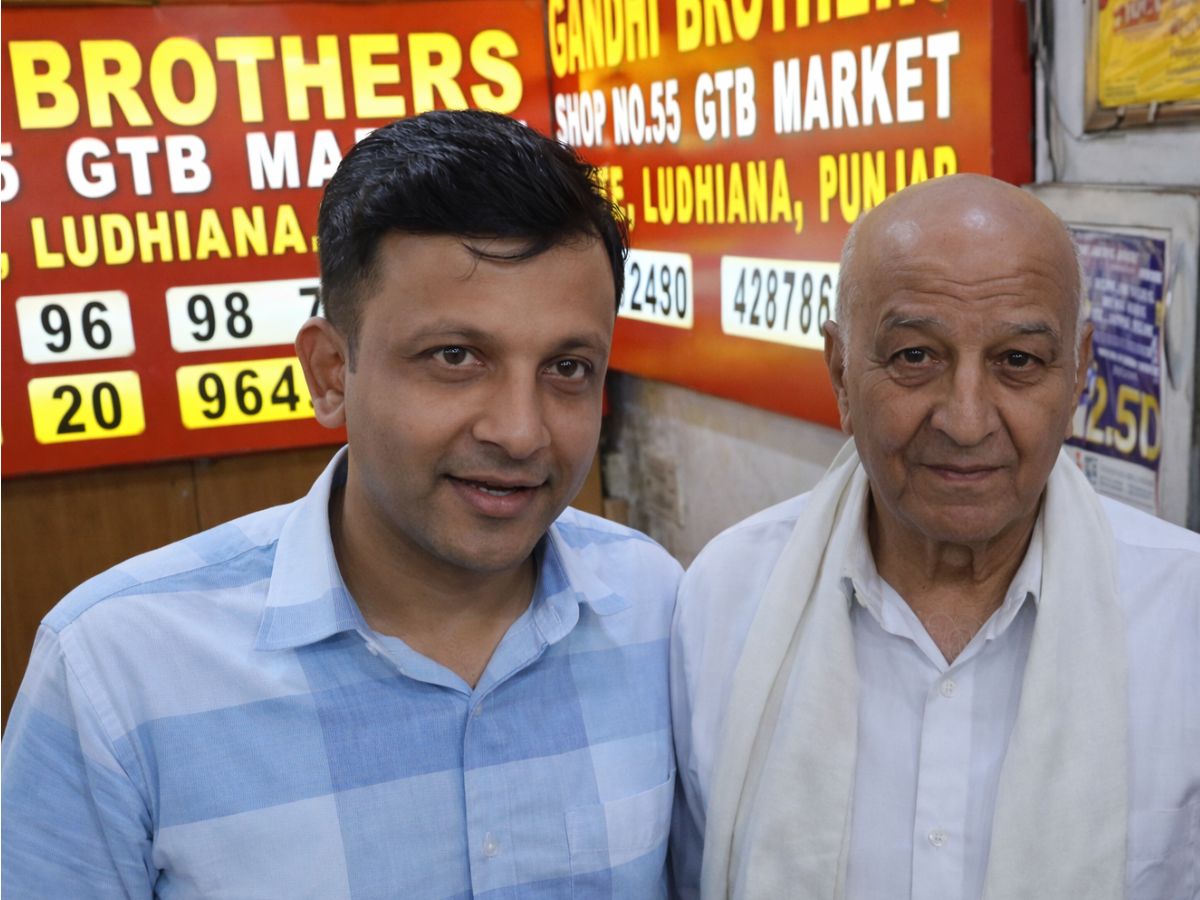 AI photo of retired postmaster who won a 6 crore lottery and his son