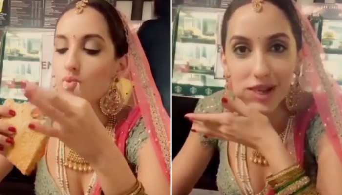 Nora Fatehi ने दुल्हन बनकर लिया चीज सैंडविच का लुत्फ, कैमरा देख दिया ये रिएक्शन Nora Fatehi ने दुल्हन बनकर लिया चीज सैंडविच का लुत्फ, कैमरा देख दिया ये रिएक्शन