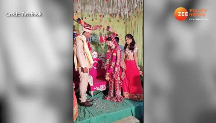 bride throwing varmala groom wore garland slogans on stage mpap