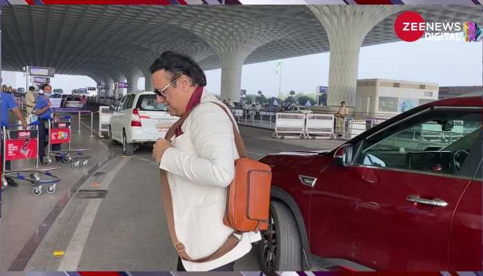 कोट के बटन खोल Hero No.1 ने मारी एयरपोर्ट पर एन्ट्री